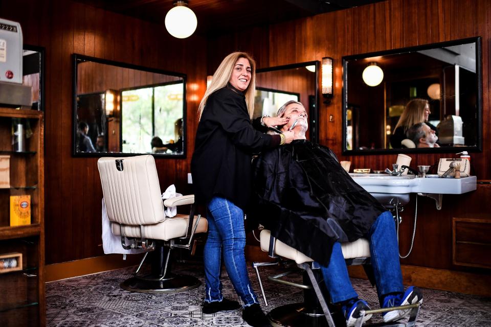 Barber Dalia Antunes, 44, poses at the Oliveira Barbershop in Lisbon, Portugal, on March 3, 2018.