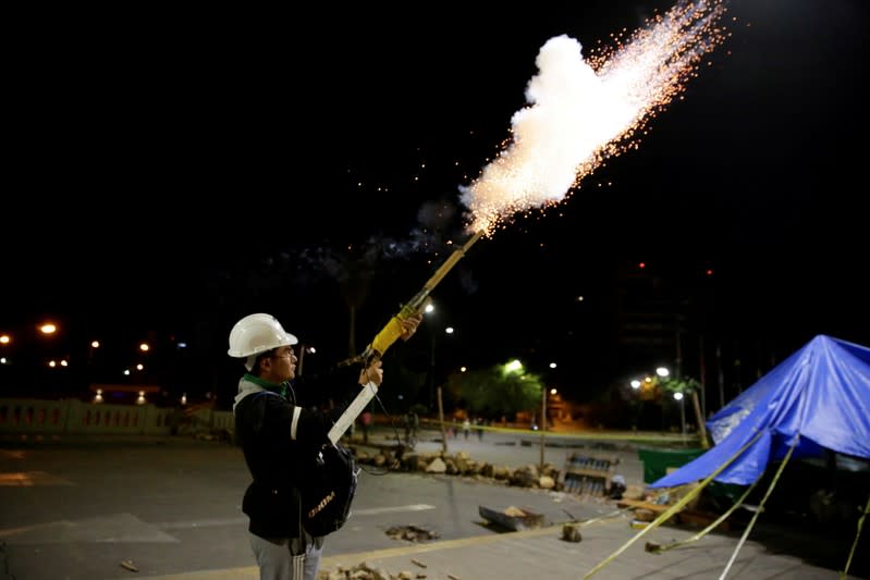 Members of Youth Resistance "Cochala" set off fireworks to celebrate after Bolivian Senator Jeanine Anez became interim president in La Paz