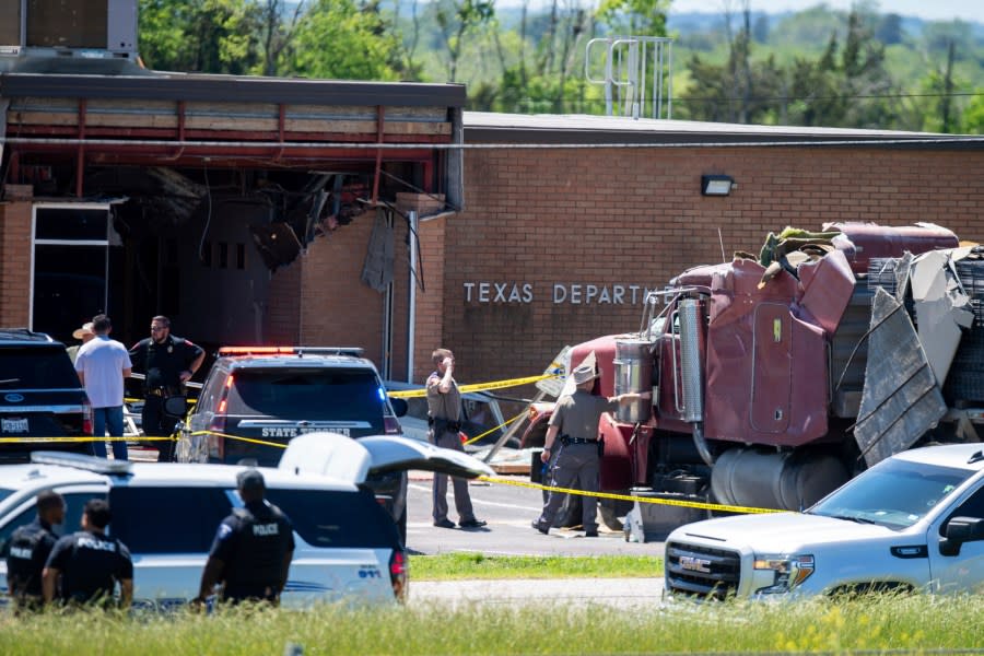 First responders on the scene after a stolen 18-wheeler crashed into a Texas Department of Public Safety office on US-290 in Brenham, Texas on Friday, April 12, 2024. The driver of a stolen semitrailer intentionally rammed it into the Texas public safety office in a rural town west of Houston on Friday, injuring multiple people, according to a state lawmaker. (Meredith Seaver /College Station Eagle via AP)