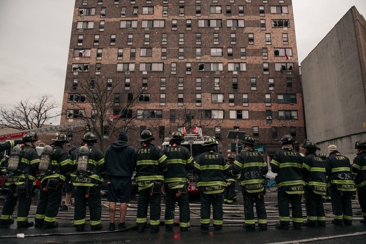 Emergency first responders remain at the scene after an intense fire at a 19-story residential building that erupted in the morning on Jan. 9, 2022, in the Bronx borough of New York City. Reports indicate over 50 people were injured.