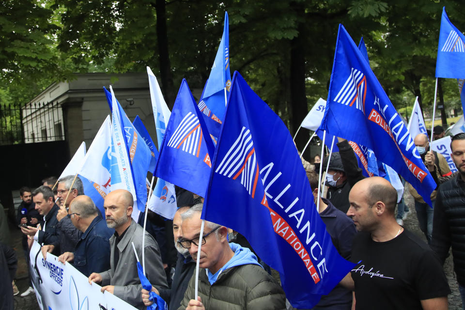 French police unionists demonstrate in front of the gardens of the presidential Elysee Palace, Friday, June 12, 2020 in Paris. French police marched through central Paris to protest what they see as a lack of government support and against a new ban on chokeholds and limits to what they can do during arrests. The decision to ban chokeholds was part of government efforts to stem police brutality and racism in the wake of global protests over George Floyd's death in the U.S. (AP Photo/Michel Euler)