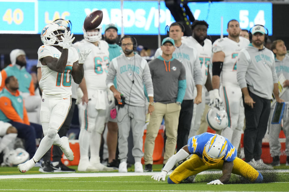 Miami Dolphins wide receiver Tyreek Hill (10) catches a touchdown past Los Angeles Chargers cornerback Michael Davis, right, during the second half of an NFL football game Sunday, Dec. 11, 2022, in Inglewood, Calif. (AP Photo/Jae C. Hong)