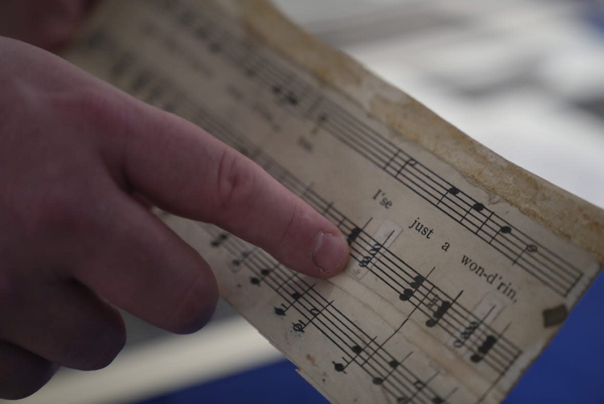 Christopher Lynch, music historian with the Center for American Music at the University of Pittsburgh, holds a piece of sheet music written by Charles Henry Pace, on Tuesday, Feb. 28, 2023, at the University of Pittsburgh, in Pittsburgh. Lynch and the university are coordinating a project to recognize the pivotal role Pace played in gospel music as an early pioneer of the genre. (AP Photo/Jessie Wardarski)