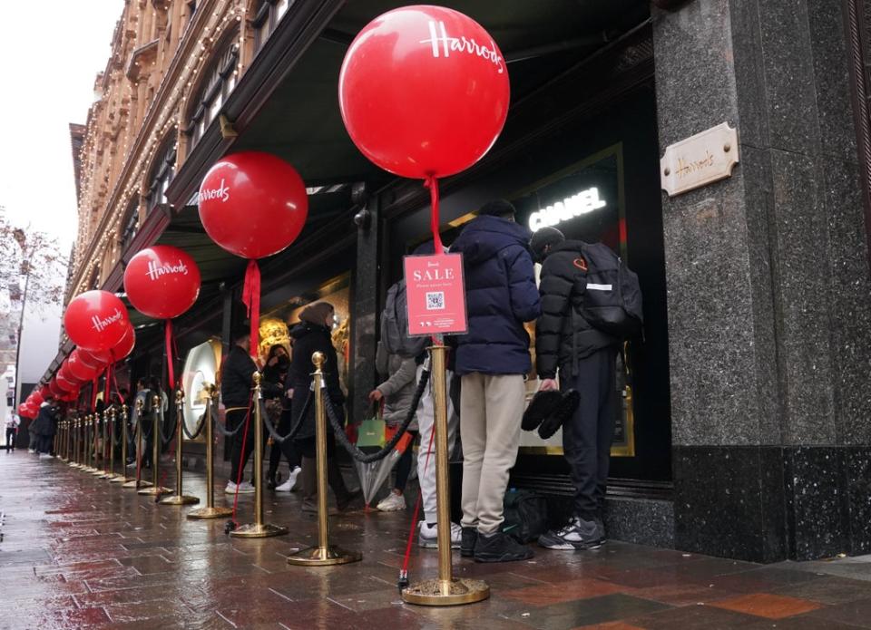 Customers begin to form a queue outside the Harrods store in Knightsbridge, London, waiting for the start the Boxing Day sales (Jonathan Brady/PA) (PA Wire)