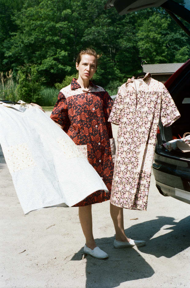 Designer Batsheva Hay wearing (and holding) Batsheva's house dresses.