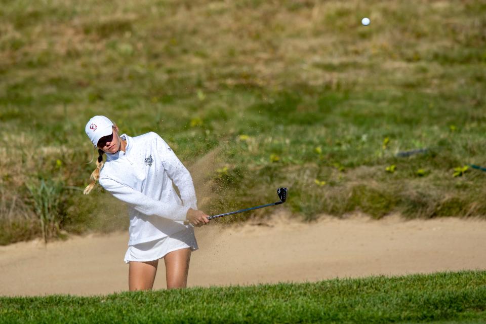 Center Grove High School senior Sage Parsetich hits out of a bunker during the first day of competition in the 50th Annual IHSAA Girls’ Golf State Championship tournament, Friday, Sept. 30, 2022, at Prairie View Golf Club in Carmel, Ind.
