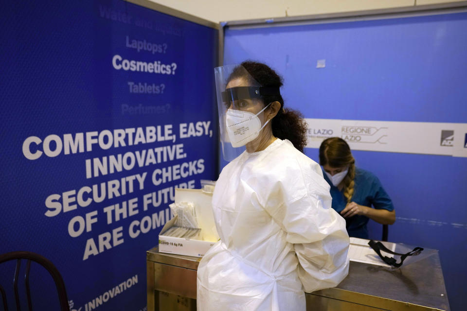 FILE - Medical personnel wait for passengers coming with an Air China flight from Guangzhou, China, in a COVID-19 testing area set at Rome's Leonardo da Vinci international airport in Fiumicino, Thursday, Dec. 29, 2022 after Italy made coronavirus tests mandatory for all airline passengers arriving from China. European Union nations are fine-tuning a coordinated response to China's COVID-19 crisis on Wednesday, Jan. 4, 2023 and are zeroing in on travel restrictions that would upset both Beijing and the global airline industry. (AP Photo/Alessandra Tarantino, File)