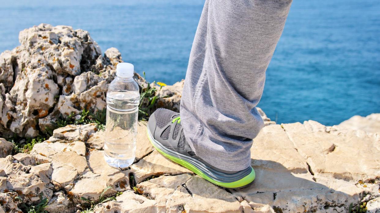 sweatpants and water bottle at ocean cliff