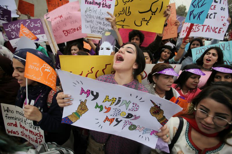 FILE PHOTO: Woman carries a sign and chants slogans during a rally to mark International Women's Day in Lahore