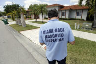 <p>Giraldo Carratala, an inspector with the Miami Dade County mosquito control unit, walks door to door while responding to a resident’s complaint about mosquitoes in the neighborhood, Tuesday, April 12, 2016, in Miami, Fla. (AP Photo/Lynne Sladky)</p>