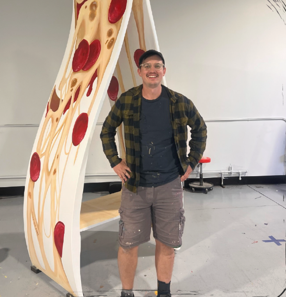 Mike Sobeck, a Cleveland based artist, who has specialized in the art of pizza painting and does murals all over the greater Cleveland area, with his ‘pizza-slice’ bench (Canvus)