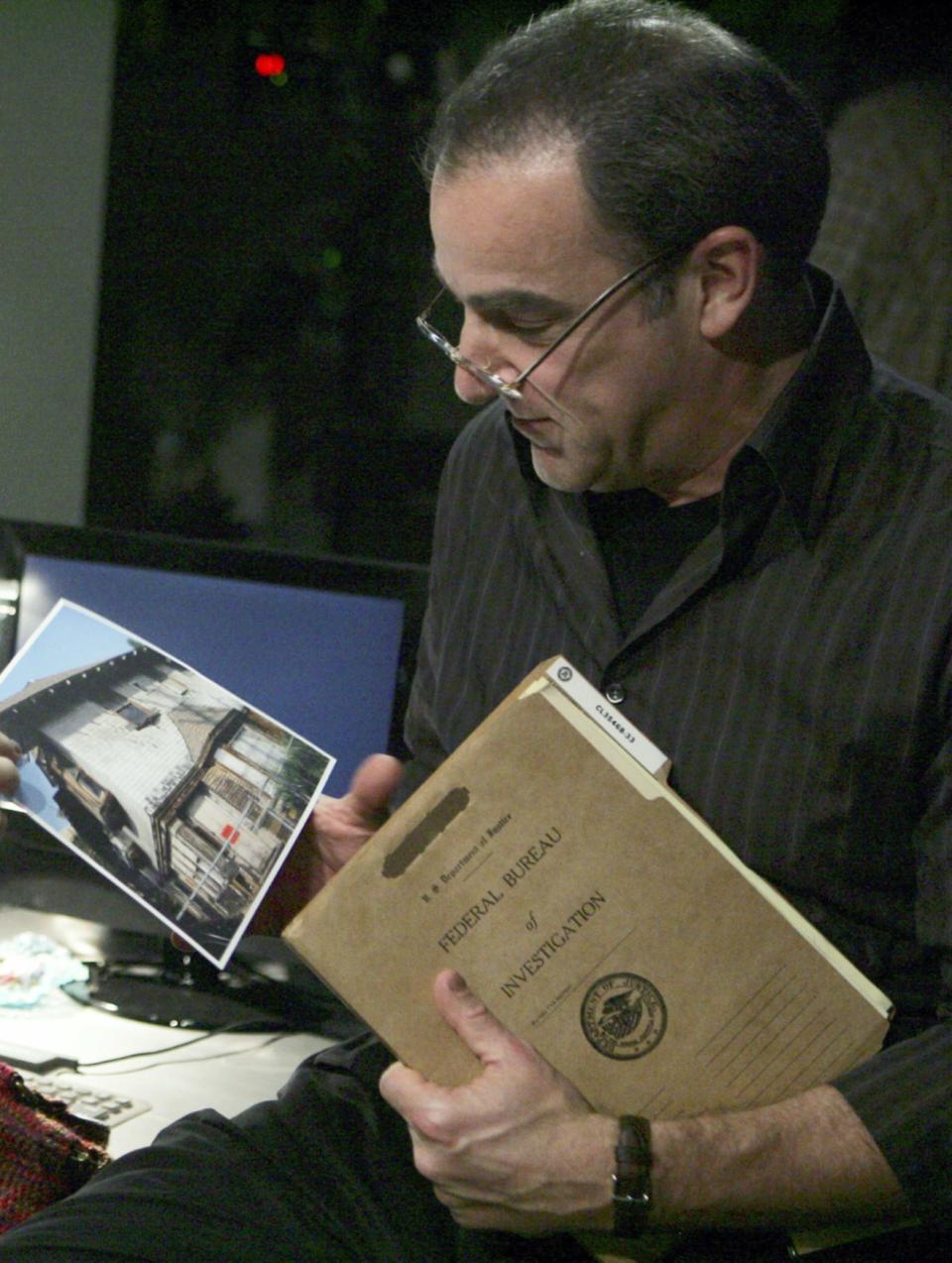 Gideon looking at a file