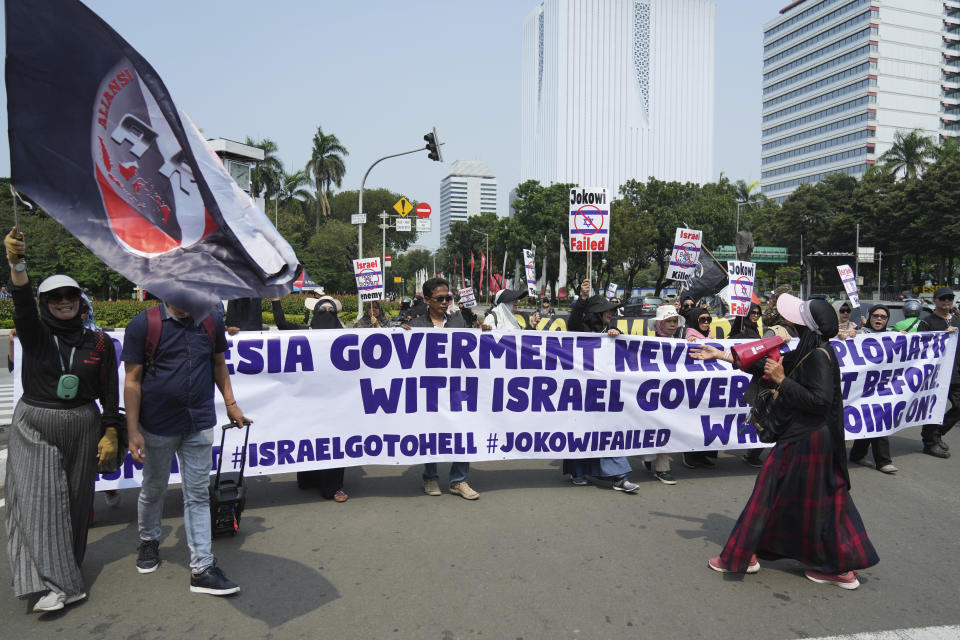 Protesters march during a protest in Jakarta, Indonesia, Monday, March 20, 2023. Hundreds of conservative Muslims have marched to the streets Monday in Indonesia's capital to protest against the Israeli team's participation in the FIFA World Cup Under-20 in Indonesia.(AP Photo/Achmad Ibrahim)