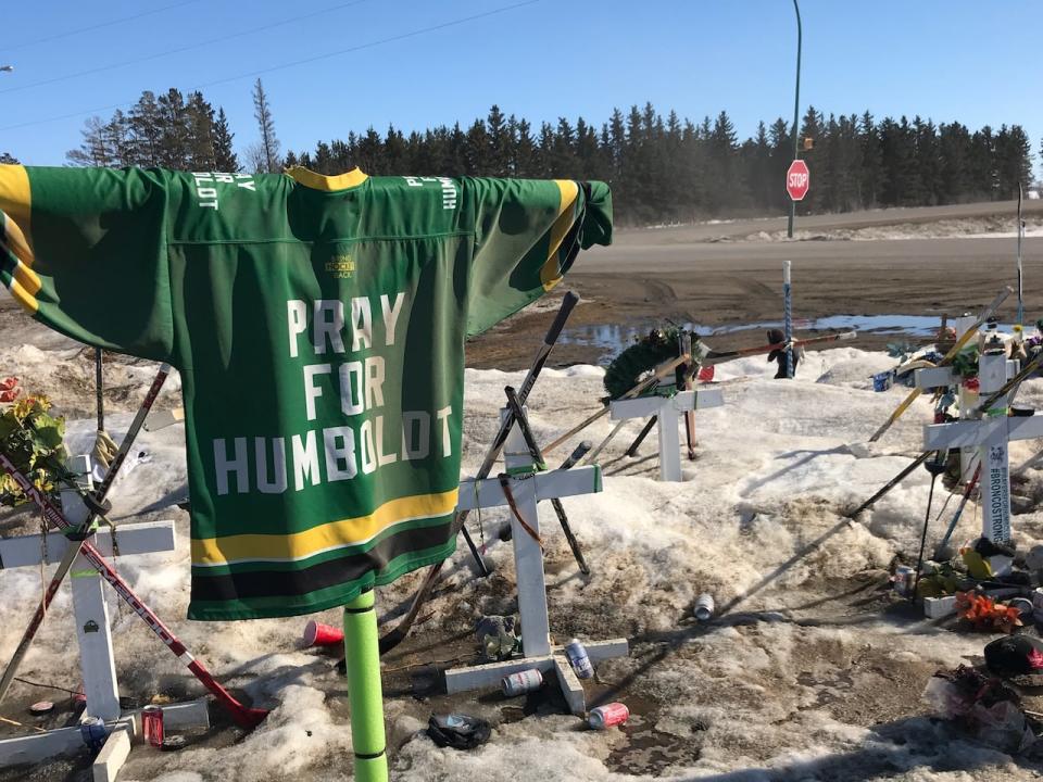 A 'pray for Humboldt' jersey is draped at the site of the Humboldt Broncos 2018 bus crash. Officials say a number of improvements have been made in driver training and intersection safety.