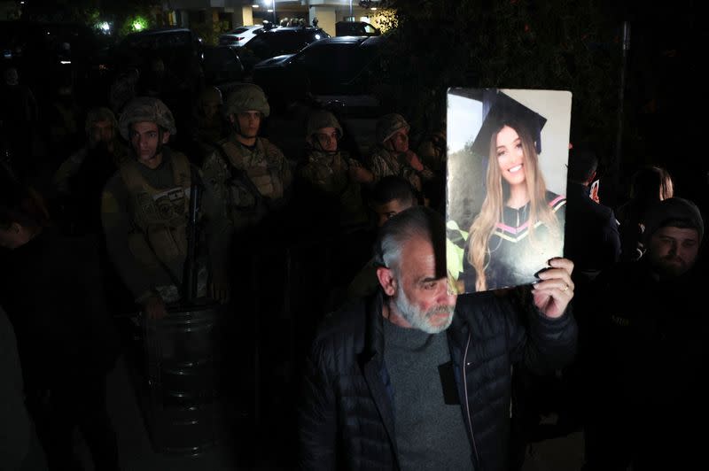 A member of the family of one of the victims of the 2020 Beirut port explosion, attends a protest against Ghassan Oweidat Lebanon's top public prosecutor, near his residence in Baabda