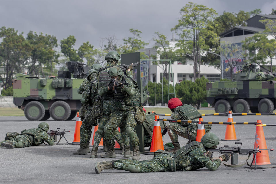 In this photo released by the Taiwan Presidential Office, soldiers take part in a drill during a visit by Taiwan's President Tsai Ing-wen, at a military base in Chiayi in southwestern Taiwan, Friday, Jan. 6, 2023. President Tsai visited a military base Friday to observe drills while rival China protested the passage of a U.S. Navy destroyer through the Taiwan Strait, as tensions between the sides showed no sign of abating in the new year. (Taiwan Presidential Office via AP)