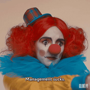 woman in clown costume saying "management sucks"
