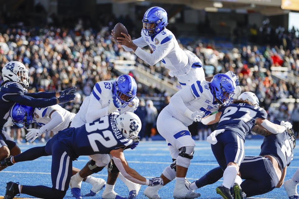 Georgia State quarterback Darren Grainger (3) jumps over the goal line for a touchdown against Utah State in the first half of the Famous Idaho Potato Bowl NCAA college football game, Saturday, Dec. 23, 2023, in Boise, Idaho. (AP Photo/Steve Conner)