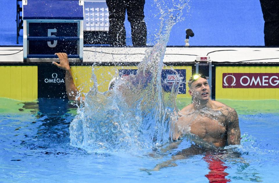 Caeleb Dressel celebrates after winning the 100-meter butterfly.