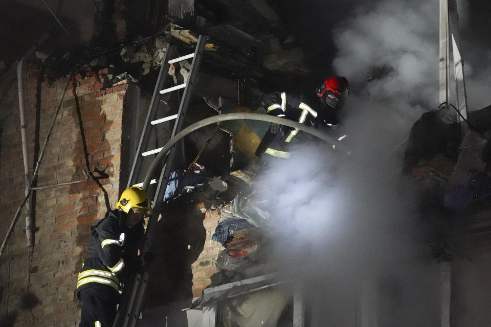 Firefighters put out a fire on an apartment building damaged in the Russian missile attack in Kharkiv, Ukraine, Friday, May, 31, 2024. (AP Photo/Andrii Marienko)