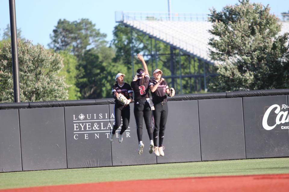 ULM outfielders celebrate before the game. The Ragin' Cajuns swept Louisiana-Monroe in the season finale.