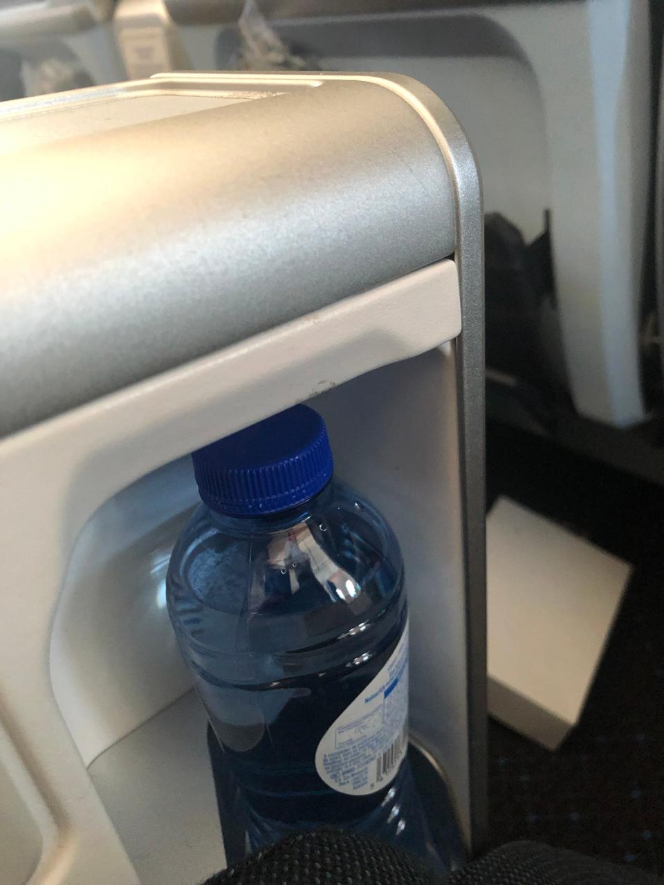 Closeup of the water bottle storage compartment on KLM's Premium Comfort seat.