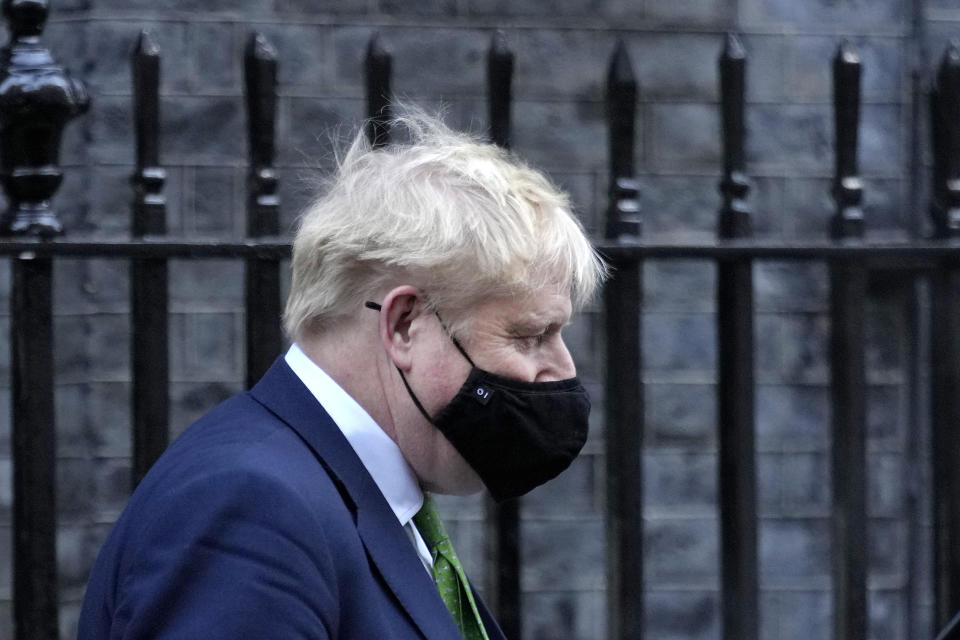 Britain's Prime Minister Boris Johnson leaves 10 Downing Street to attend the weekly session of Prime Minister's Questions in Parliament in London, Wednesday, Jan. 19, 2022. (AP Photo/Kirsty Wigglesworth)