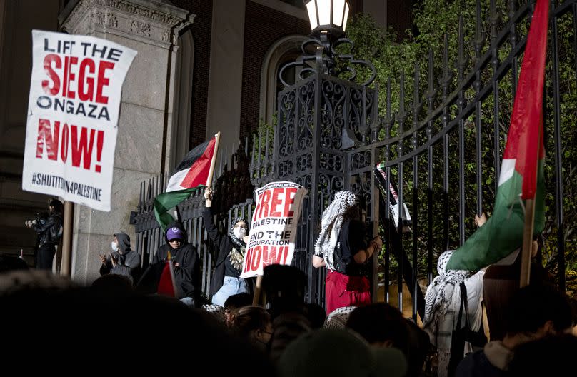 Pro-Palestianian protesters gather near a main gate at Columbia University in New York, Tuesday, April 30, 2024