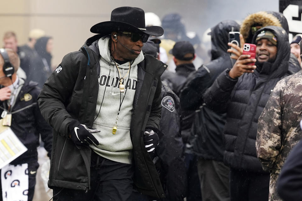 Colorado head coach Deion Sanders runs out for the team's spring NCAA college football game Saturday, April 27, 2024, in Boulder, Colo. (AP Photo/David Zalubowski)