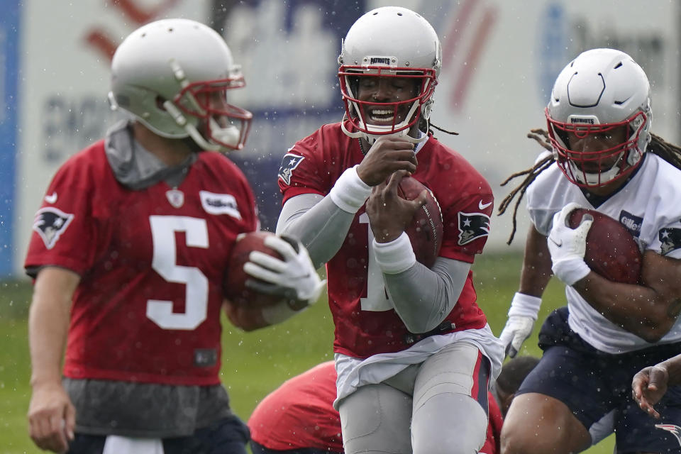 New England Patriots quarterbacks Brian Hoyer (5) and Cam Newton (1) and tight end Jakob Johnson, right, perform field drills during an NFL football practice, Monday, June 14, 2021, in Foxborough, Mass. (AP Photo/Steven Senne)