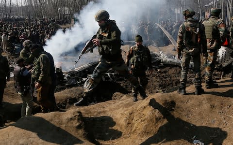 Indian army soldiers arrive near the wreckage of an Indian aircraft after it crashed in Budgam area - Credit: Mukhtar Khan/AP