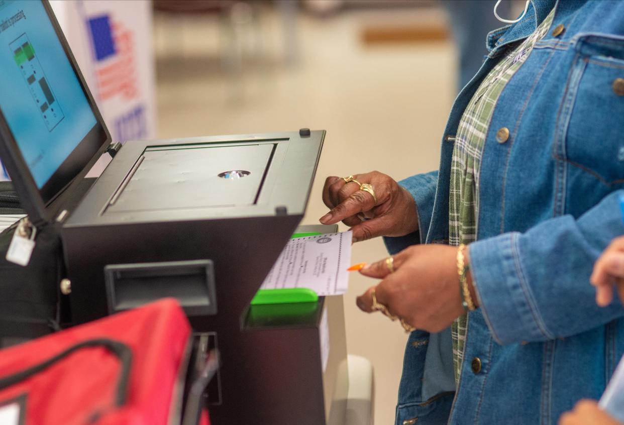 File - Sandra Bynum of Bensalem helps place a ballot into a voting machine. The Bucks County Board of Elections is preparing now for November's general election. [WILLIAM THOMAS CAIN / PHOTOJOURNALIST]