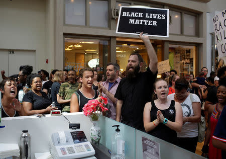 People march through West County Mall a day after the not guilty verdict in the murder trial of Jason Stockley, a former St. Louis police officer, charged with the 2011 shooting of Anthony Lamar Smith, who was black, in St. Louis, Missouri, U.S., September 16, 2017. REUTERS/Joshua Lott