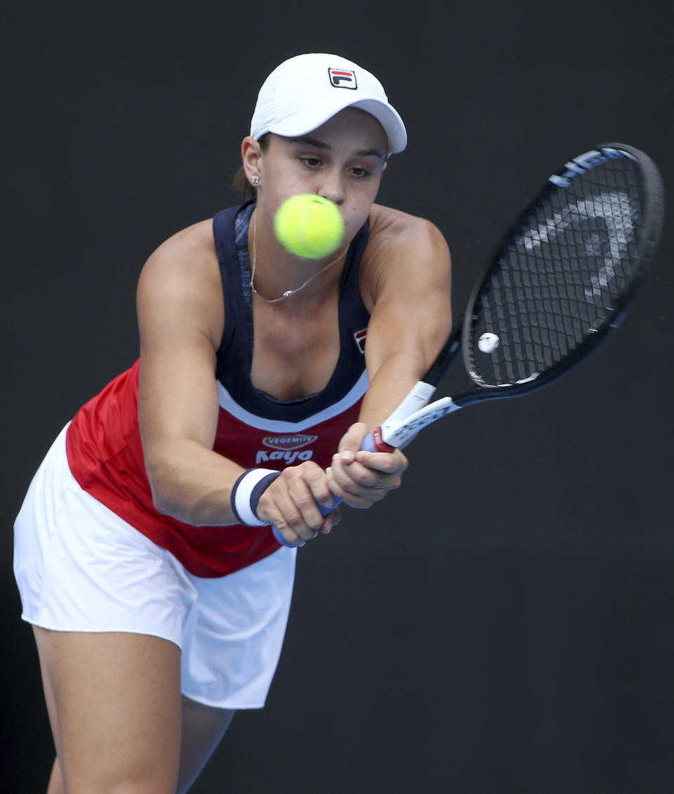 Ash Barty of Australia hits a backhand to Kiki Bertens of the Netherlands during their women's singles semifinal match at the Sydney International tennis tournament in Sydney, Friday, Jan. 11, 2019. (AP Photo/Rick Rycroft)