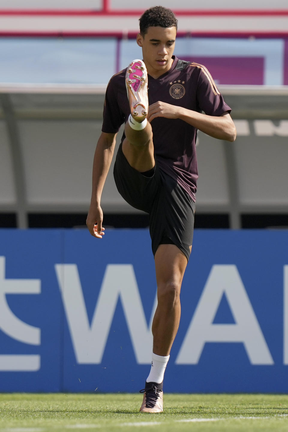 Germany's Jamal Musiala warms up for a training session at the Al-Shamal stadium on the eve of the group E World Cup soccer match between Germany and Japan, in Al-Ruwais, Qatar, Tuesday, Nov. 22, 2022. Germany will play the first match against Japan on Wednesday, Nov. 23. (AP Photo/Matthias Schrader)