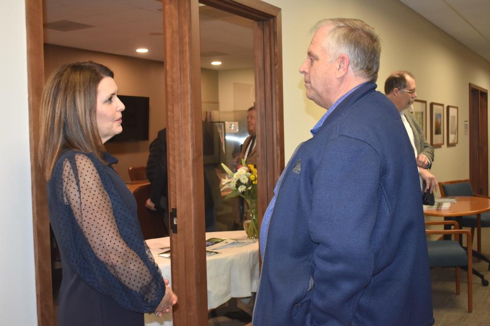 New Lenawee Community Foundation President and CEO Bronna Kahle, left, shares a conversation with Ron Wimple, Tecumseh City Council member, during a meet-and-greet event Jan. 17, 2023, at the foundation's office in Adrian.