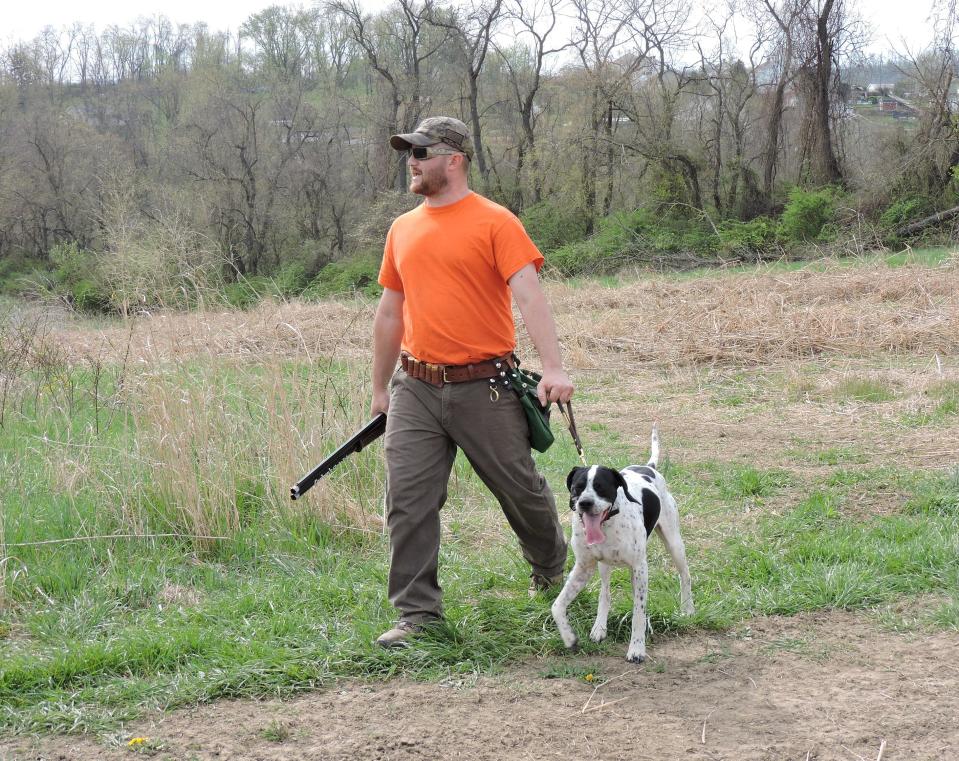 Nate Hilligus leds his dog Dax back from a trial competition in Fayette County.