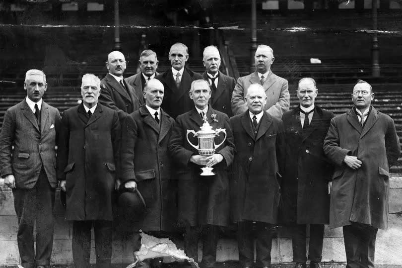 Airdrie directors pose with the Scottish Cup at Ibrox Stadium, Glasgow, after their side had beat Hibs 2-0