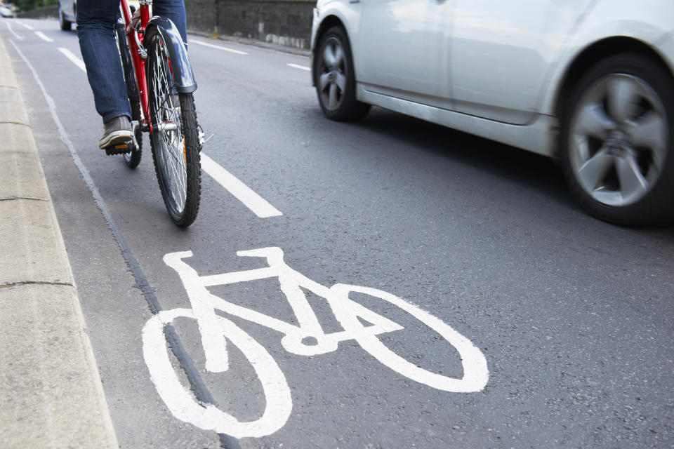 A cyclist riding next to car. Source: Getty Images