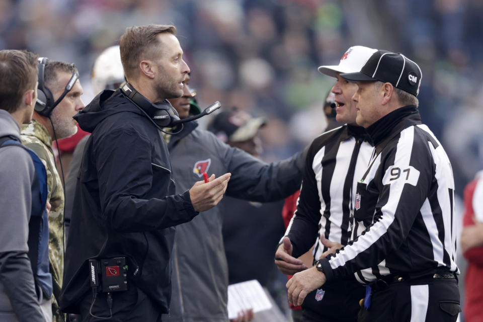 Arizona Cardinals head coach Kliff Kingsbury talks with officials during the first half of an NFL football game against the Seattle Seahawks, Sunday, Nov. 21, 2021, in Seattle. (AP Photo/John Froschauer)