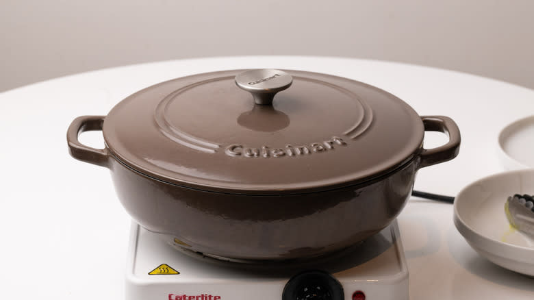 covered ceramic pan heating on stove