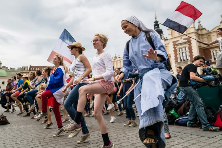 Young people and a nun from France celebrate at the market square in Krakow, Poland, on July 25, 2016