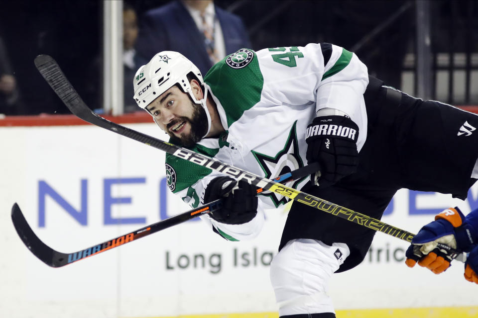 FILE - In this Feb. 4, 2020, file photo, Dallas Stars' Roman Polak (45) shoots on goal during the first period of an NHL hockey game against the New York Islanders in New York. Edmonton’s Mike Green and Vancouver’s Sven Baertschi are opting out. Polak is not reporting for now. And Tampa Bay captain Steven Stamkos is not reporting at full strength. Green and Baertschi joined Calgary defender Travis Hamonic in choosing not to participating in the resumption of the NHL season. Polak is not on the Stars’ roster for the start of training camp, and a team spokesman said the 34-year-old will not be attending at this time. (AP Photo/Frank Franklin II, File)