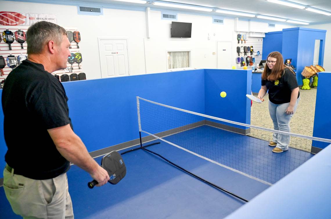 Owner Greg Stokes and his daughter Brayden Stokes demonstrate the small court at Pickleball Sports at 4446 Forsyth Road in Macon. Jason Vorhees/The Telegraph