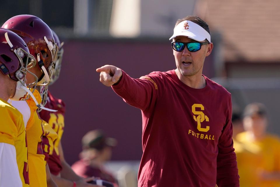 Southern California head coach Lincoln Riley talks with his quarterbacks during an NCAA college football practice Thursday, March 24, 2022, in Los Angeles. (AP Photo/Mark J. Terrill)