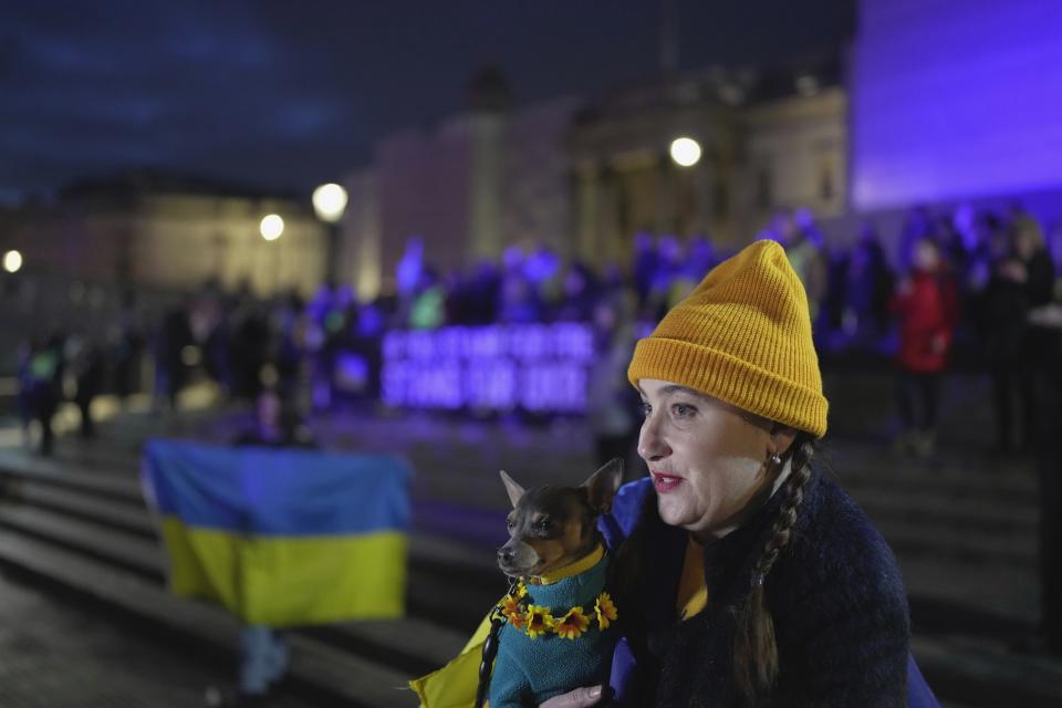 People attend a vigil at the Trafalgar Square organised by the Ukrainian and US Embassy, ahead of the one-year anniversary of the invasion of Ukraine, in London, Thursday, Feb. 23, 2023. (AP Photo/Kin Cheung)