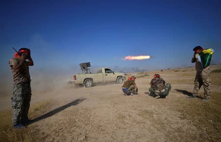 Shi'ite Popular Mobilization Forces (PMF) launch a rocket towards Islamic State militants on the outskirts of Tal Afar, Iraq, August 22, 2017. REUTERS/Stringer