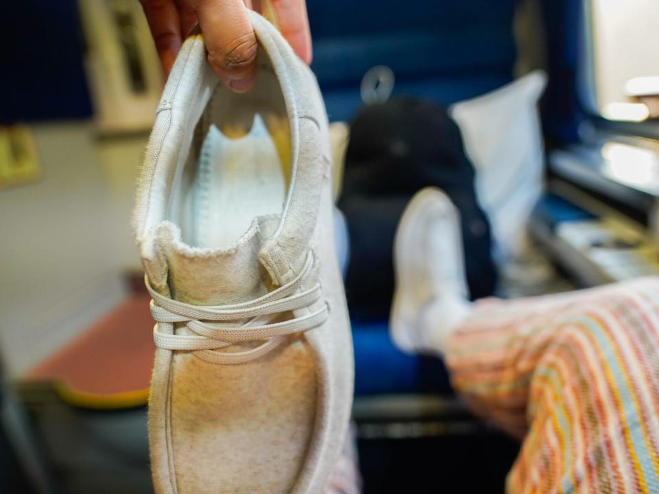 The author holds up her comfy shoe