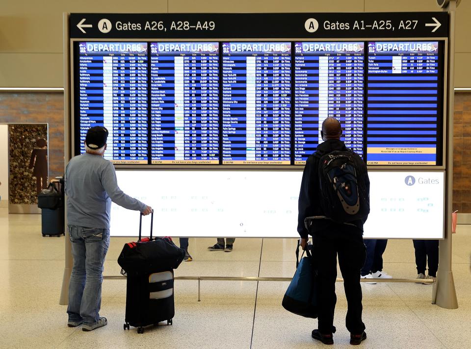 Travelers look at an information board at Salt Lake City International Airport in Salt Lake City on Tuesday, Oct. 31, 2023. | Kristin Murphy, Deseret News