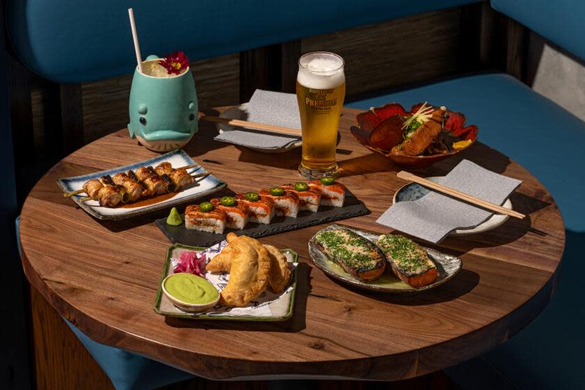 LOS ANGELES CA - APRIL 12: Table Spread of Negima, Curry Pan, Charred Sweet Potato, Hamachi Collar and Aburi Salmon Oshizushi with Joshikai Cocktail and draft beer at Budonoki on Friday April 12, 2024 in Los Angeles, CA. (Ron De Angelis / For The Times)